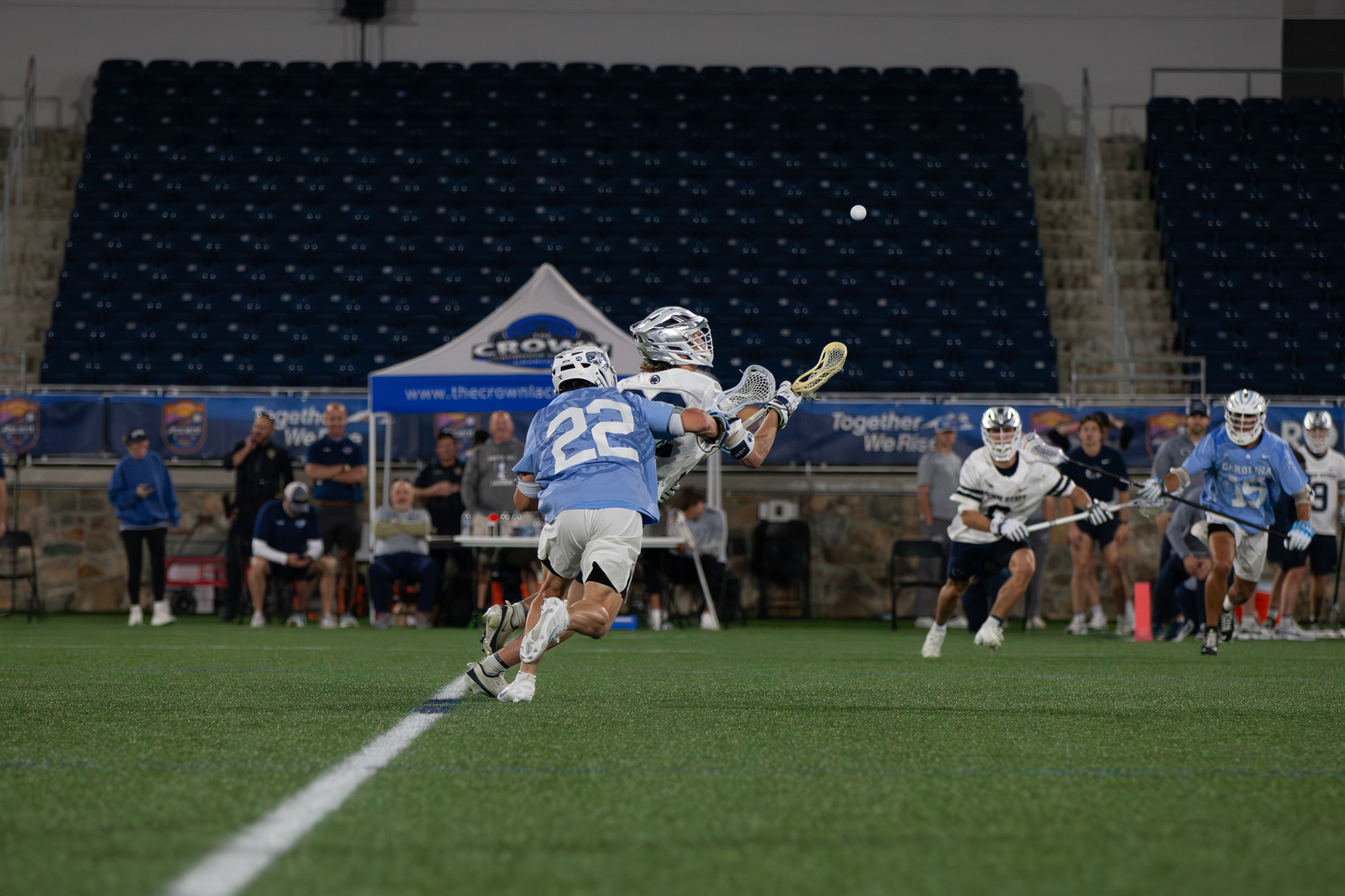 photo of UNC Men's Lacrosse team fighting for the ball mid-air in game against Penn.