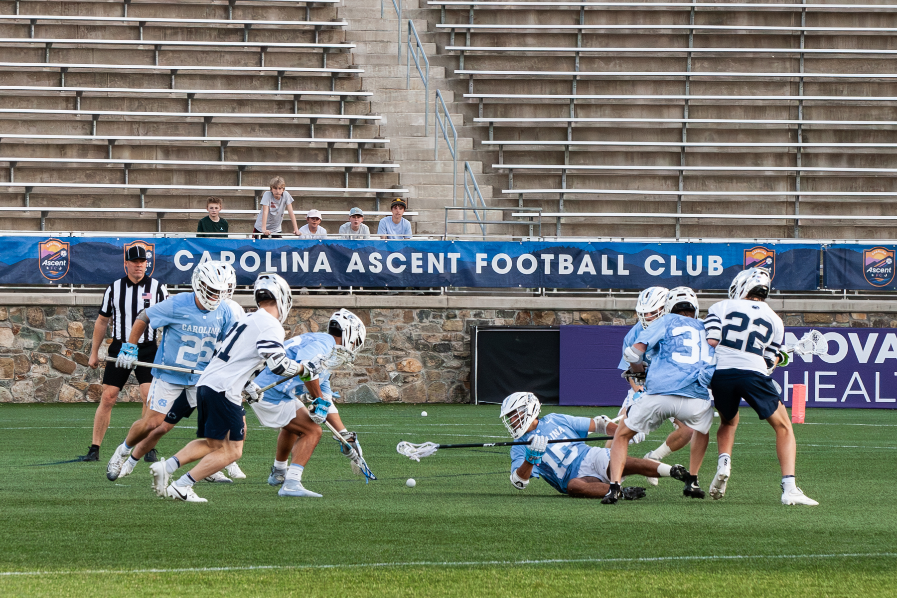 photo of UNC Men's Lacrosse team fighting for the ball on the ground in game against Penn.